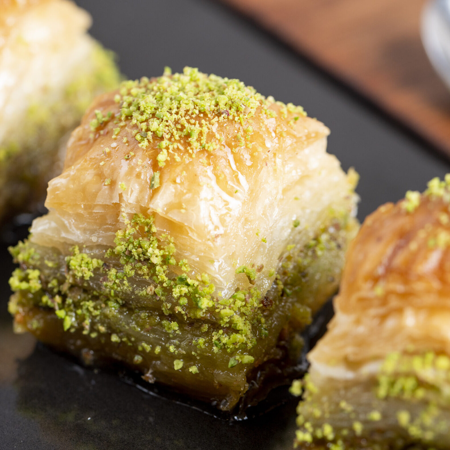 close up view of traditional turkish baklava with pistachio on a black board Baklava
